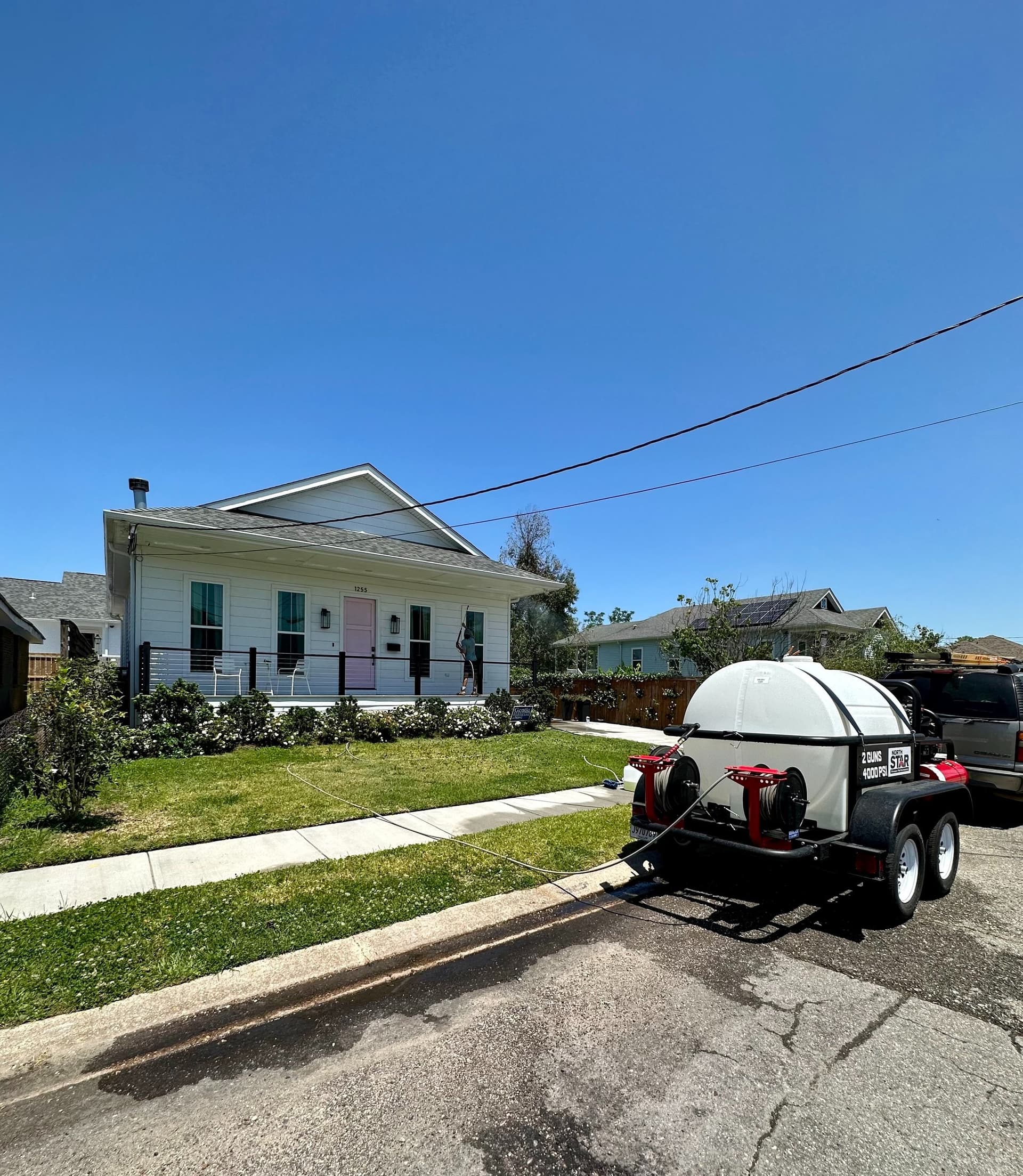 Sparky's Pressure Washing crew cleaning a driveway in New Orleans